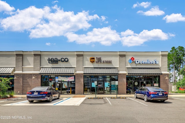 view of building exterior with uncovered parking