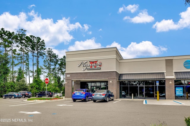 view of building exterior featuring uncovered parking