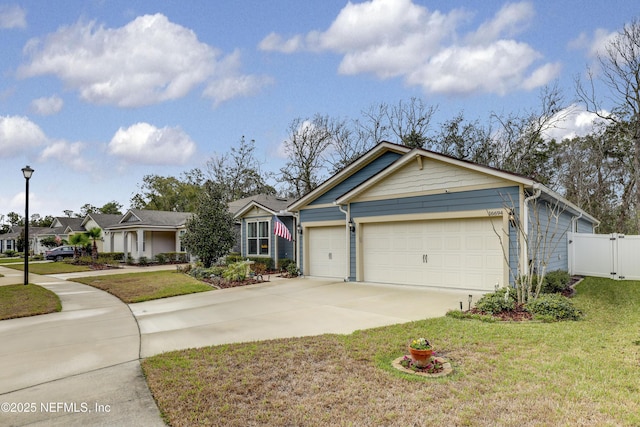 ranch-style home with a garage, a gate, a front lawn, and concrete driveway