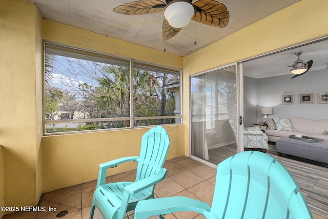 sunroom with a wealth of natural light and ceiling fan