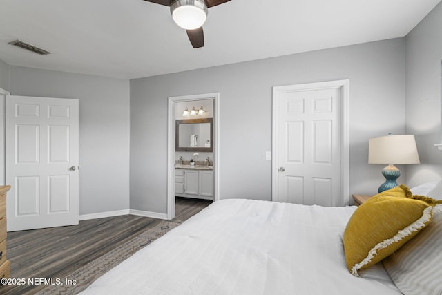 bedroom featuring ceiling fan, connected bathroom, and dark hardwood / wood-style flooring