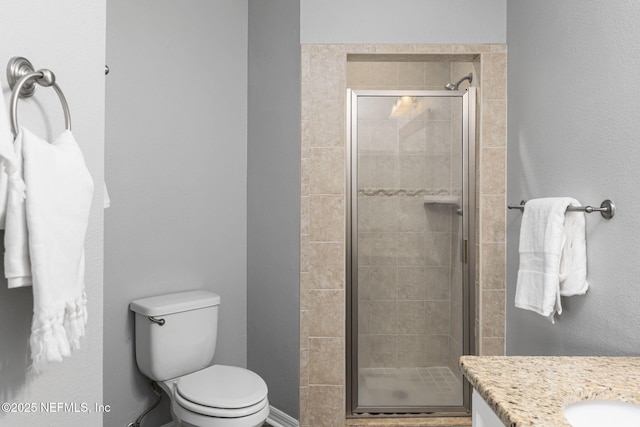 bathroom with vanity, an enclosed shower, and toilet