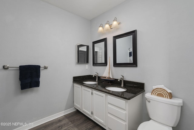 bathroom featuring vanity, hardwood / wood-style floors, and toilet