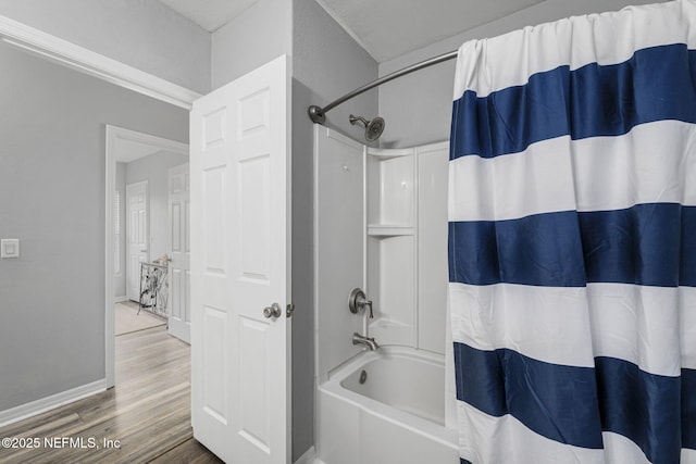 bathroom featuring hardwood / wood-style flooring and shower / bath combination with curtain