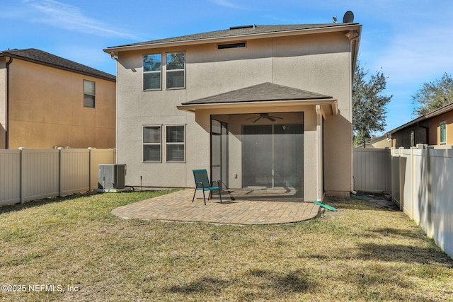 rear view of property featuring ceiling fan, a yard, a patio area, and central air condition unit