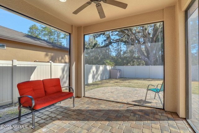 sunroom featuring ceiling fan