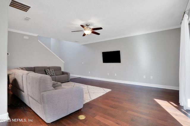 living room with crown molding, dark hardwood / wood-style floors, and ceiling fan