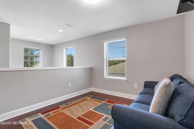 living area with a textured ceiling