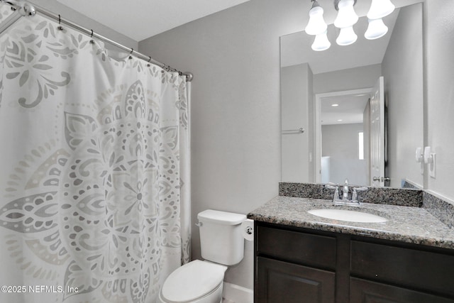 bathroom featuring vanity, a shower with curtain, and toilet