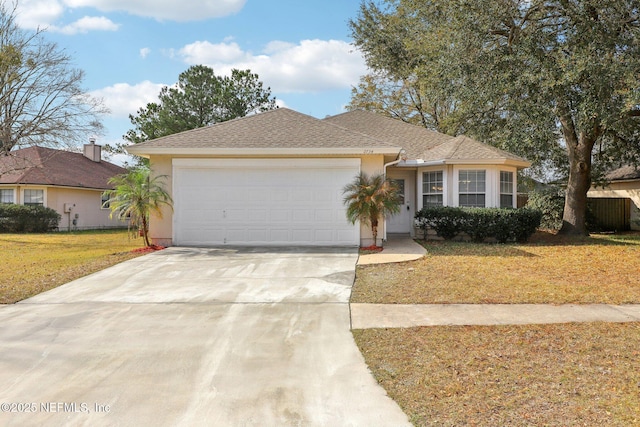 ranch-style home featuring a garage and a front yard