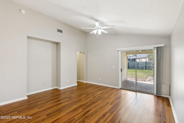 spare room featuring vaulted ceiling, dark wood-type flooring, and ceiling fan