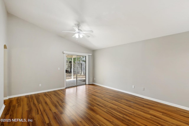 unfurnished room featuring vaulted ceiling, dark hardwood / wood-style floors, and ceiling fan