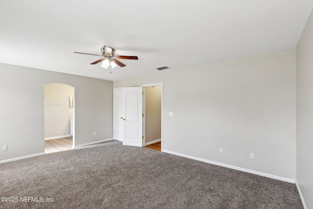 empty room with ceiling fan and carpet flooring