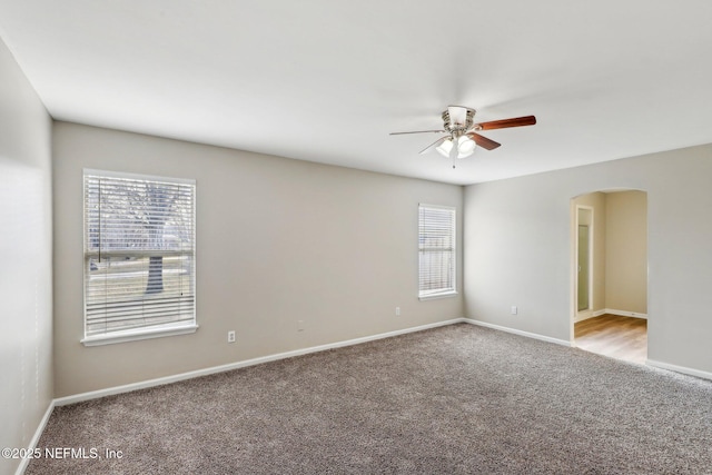 carpeted spare room featuring ceiling fan