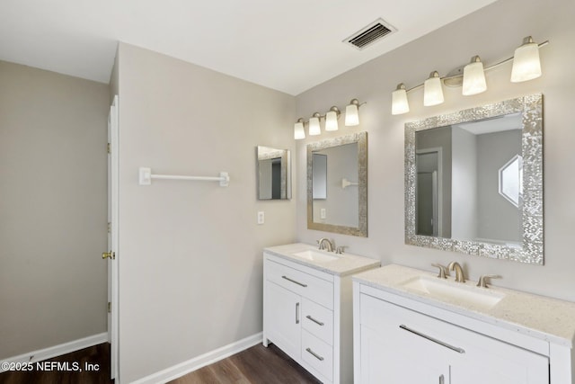 bathroom featuring vanity and hardwood / wood-style floors