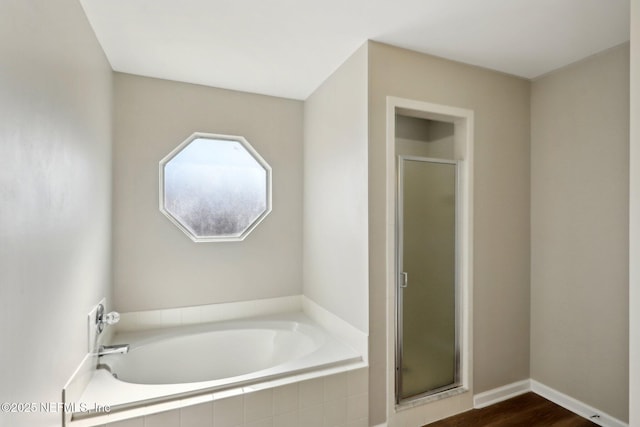 bathroom featuring hardwood / wood-style flooring and independent shower and bath