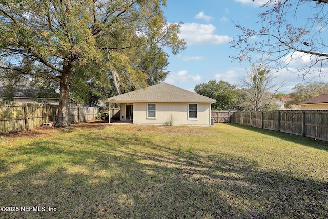 back of property featuring a yard