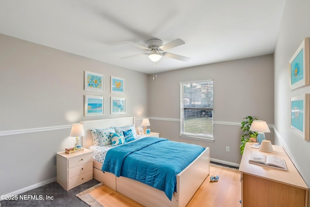 bedroom featuring light hardwood / wood-style floors and ceiling fan