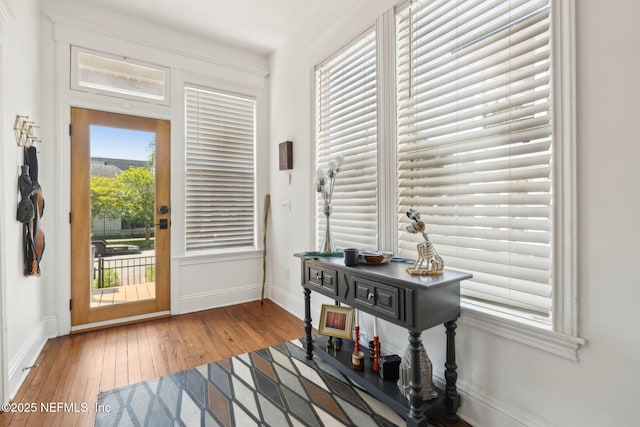 foyer entrance with hardwood / wood-style flooring and baseboards