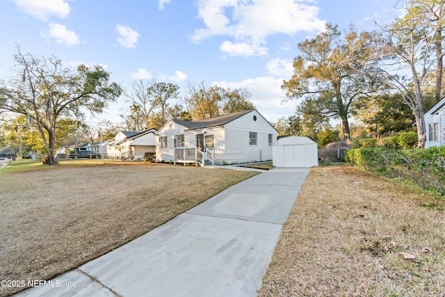 view of front of property with a storage shed and a front yard