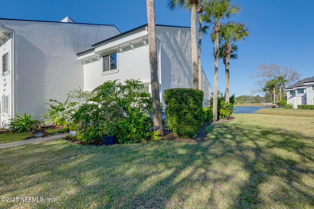 view of side of home with a lawn