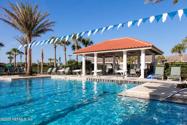 view of pool with a gazebo, a patio, and ceiling fan