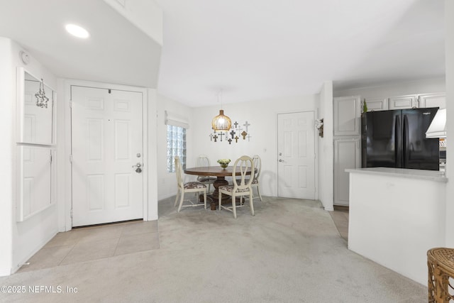 unfurnished dining area featuring light carpet