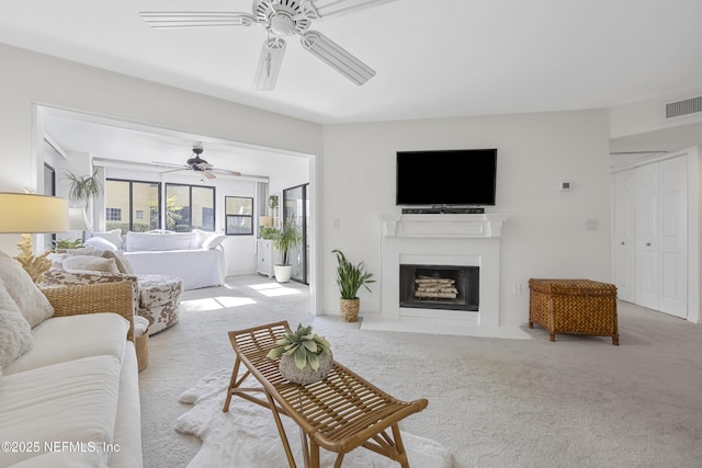 living room with ceiling fan and light colored carpet