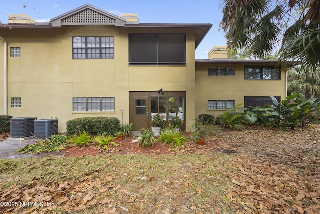 rear view of property with central AC