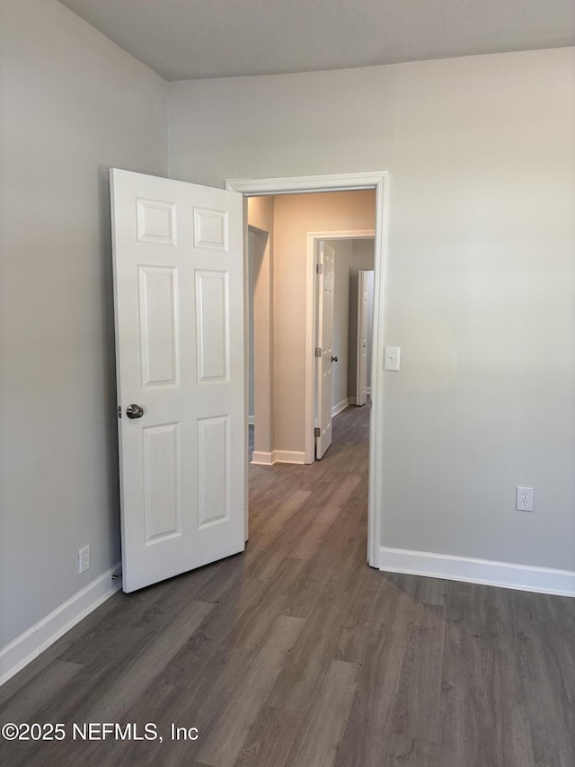 unfurnished room featuring dark hardwood / wood-style flooring