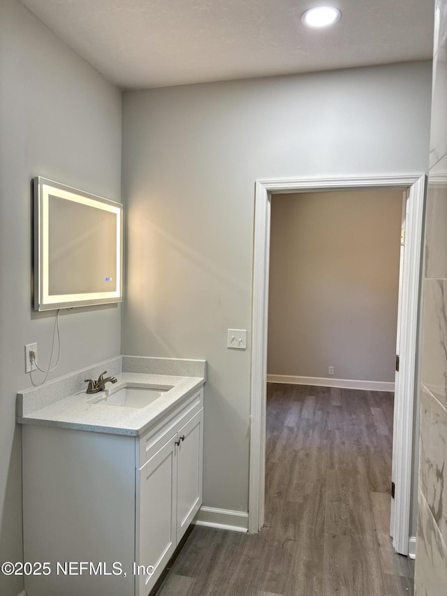 bathroom featuring hardwood / wood-style flooring and vanity