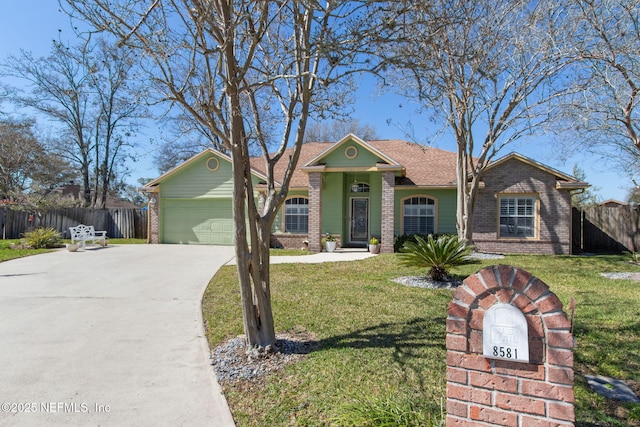 view of front of house featuring brick siding, fence, a front yard, a garage, and driveway