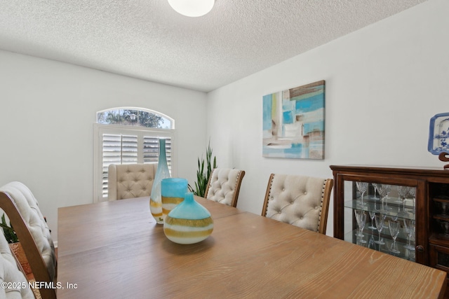 dining area with a textured ceiling