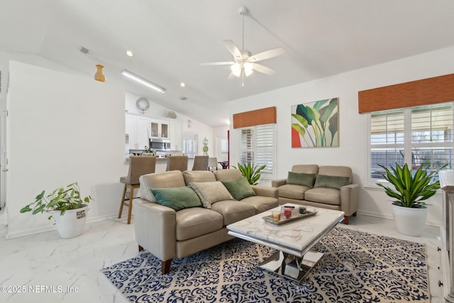 living area featuring baseboards, marble finish floor, a ceiling fan, and vaulted ceiling