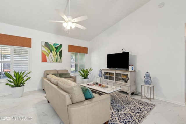 living room featuring a ceiling fan, marble finish floor, and baseboards