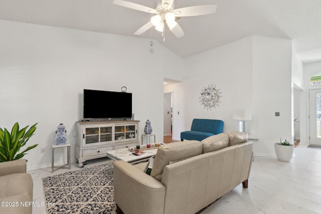 living area featuring vaulted ceiling, a ceiling fan, marble finish floor, and baseboards