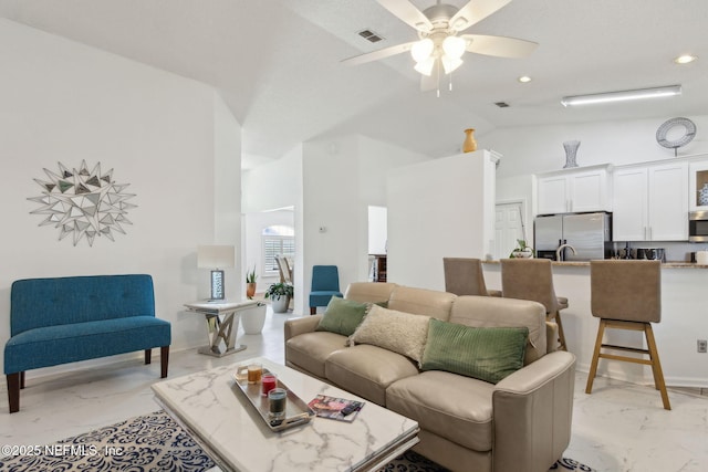 living area featuring high vaulted ceiling, visible vents, marble finish floor, and ceiling fan