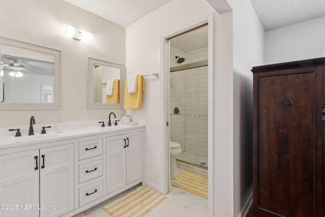 bathroom with a stall shower, a textured ceiling, and a sink