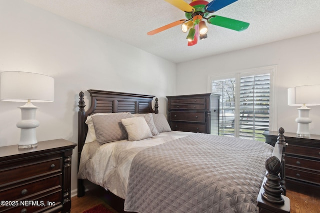 bedroom featuring ceiling fan, wood finished floors, and a textured ceiling