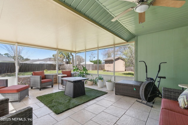 sunroom / solarium featuring ceiling fan