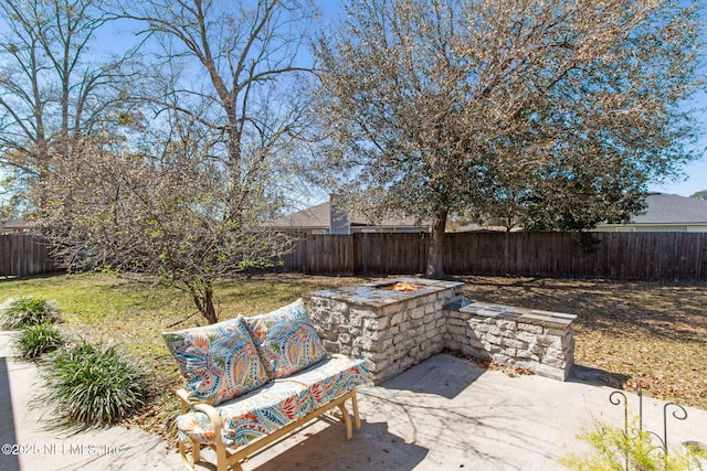 exterior space with a fenced backyard and an outdoor fire pit