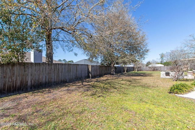 view of yard with a fenced backyard