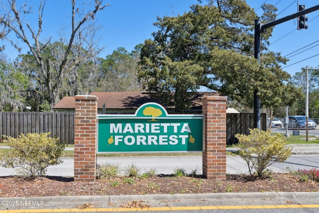 community sign with fence