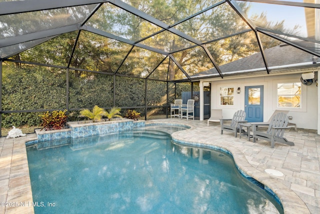 view of swimming pool with glass enclosure and a patio area