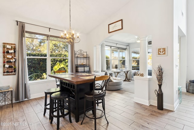 dining space with a notable chandelier and decorative columns