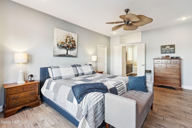 bedroom featuring ceiling fan and ensuite bath