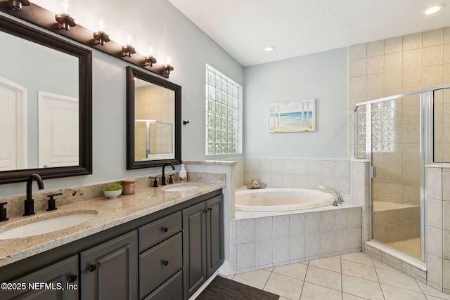 bathroom with vanity, shower with separate bathtub, and tile patterned flooring