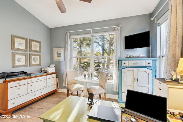 home office featuring lofted ceiling, light hardwood / wood-style floors, and ceiling fan