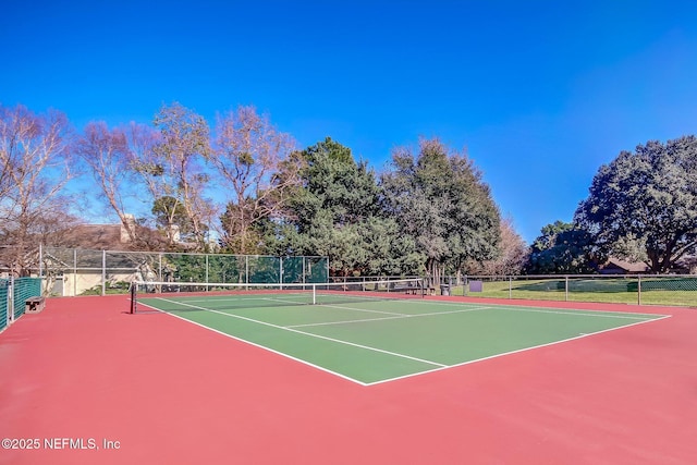 view of tennis court featuring basketball hoop