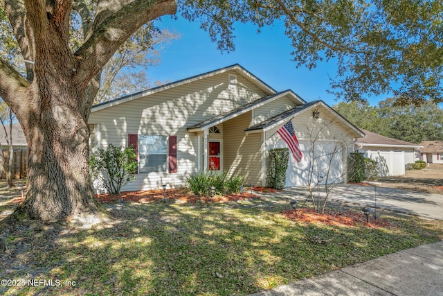 view of front of house featuring a garage and a front lawn